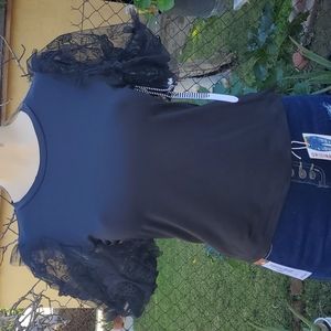 Cute black top with butterflies on the sleeve. The sleeve is like a mesh materia